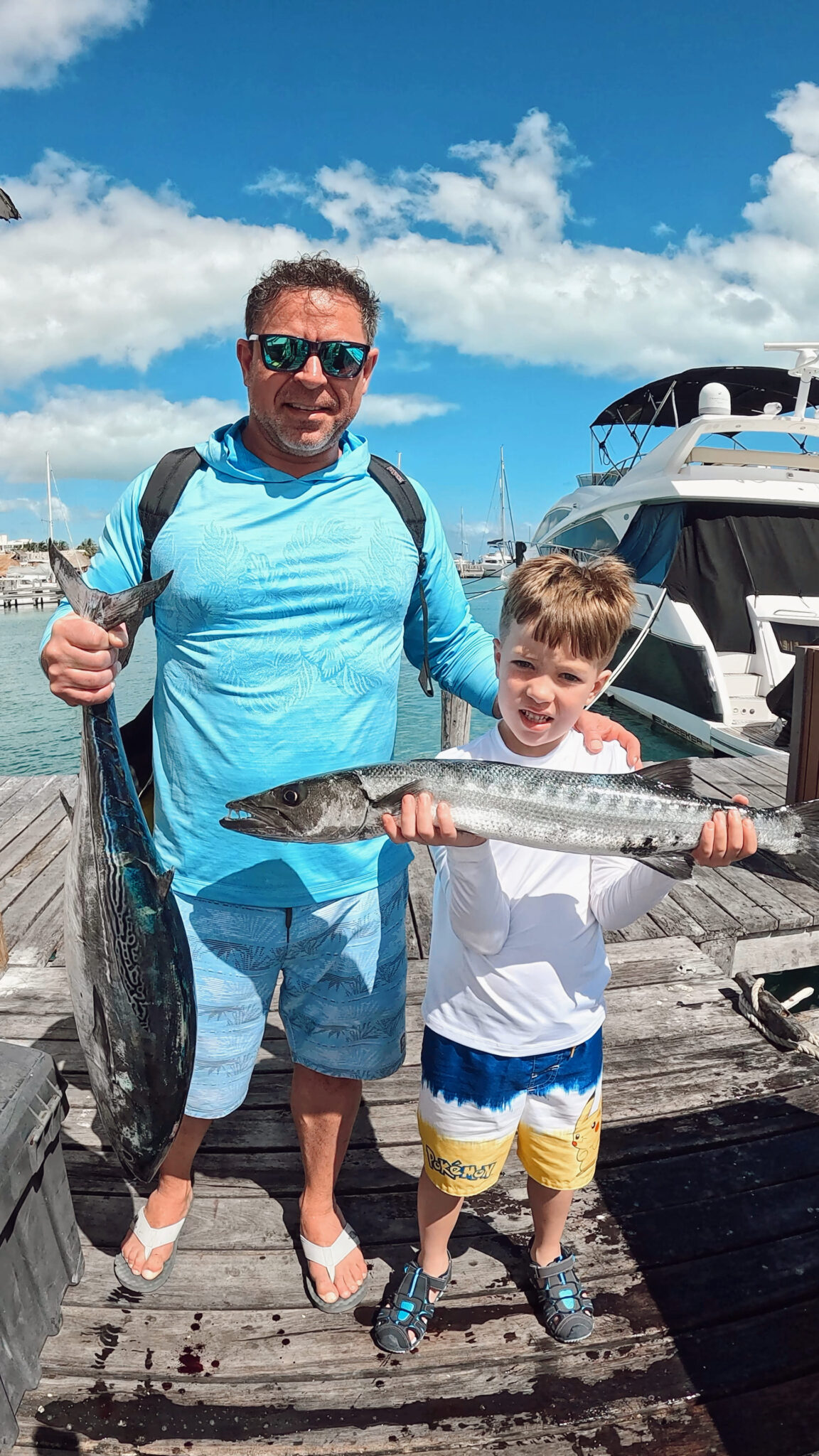 Young angler holding a barracuda