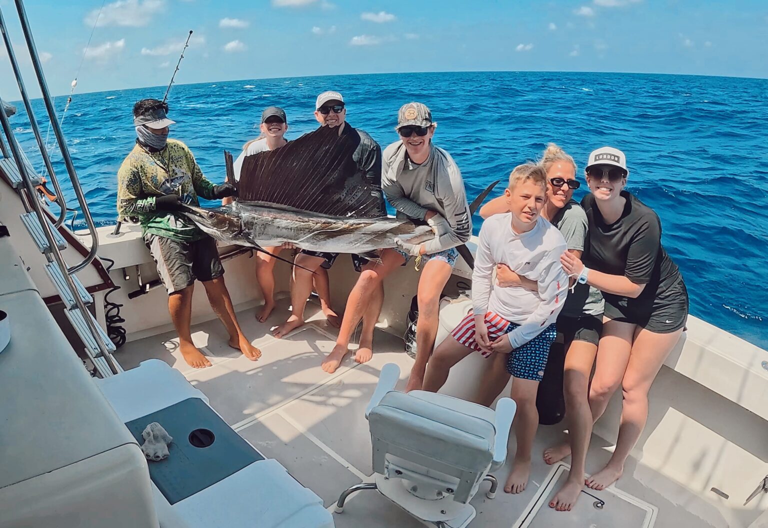 Guest and mate holding a sailfish