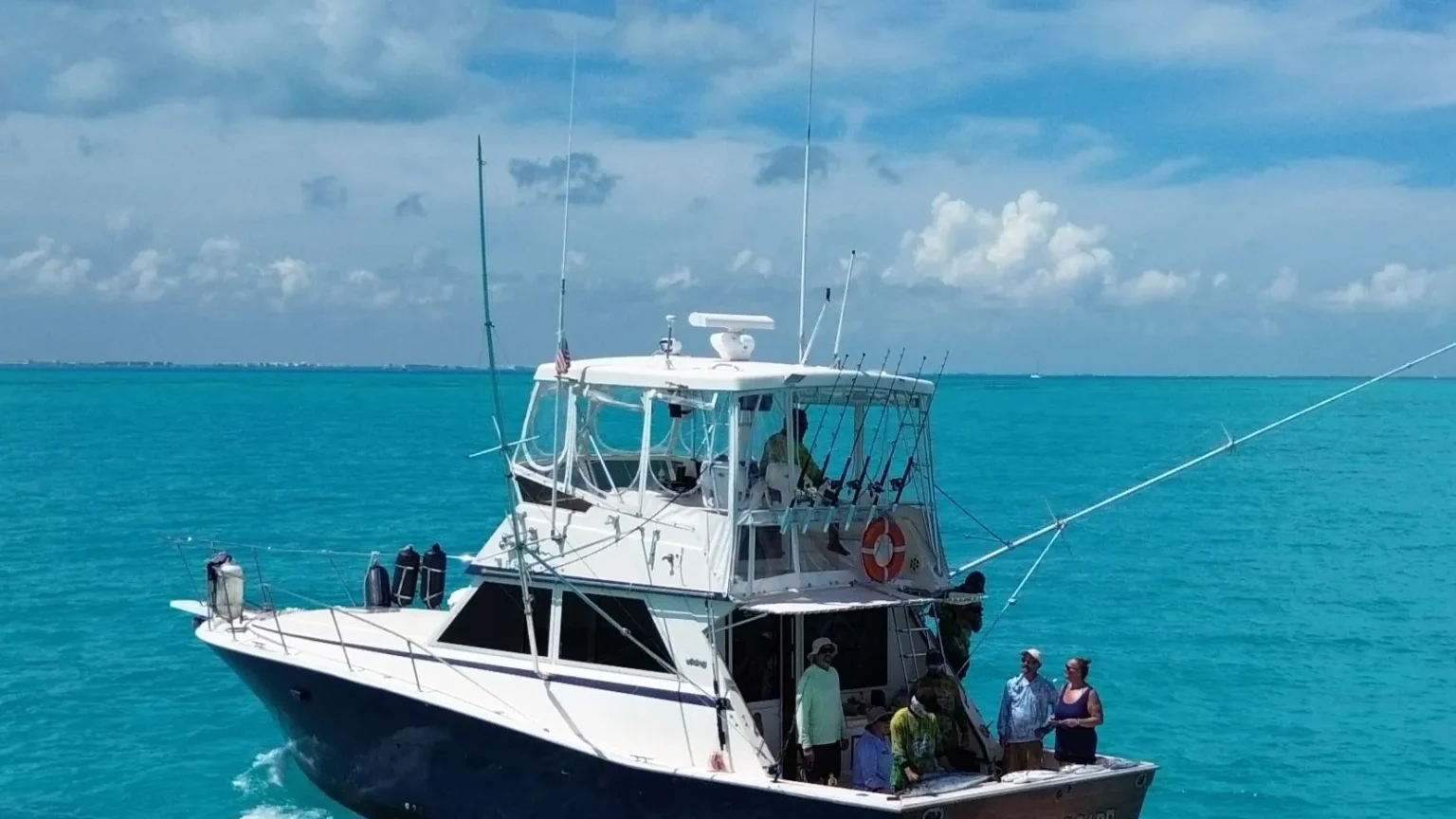 Cape Escape private fishing boat on turquoise water off Cancún