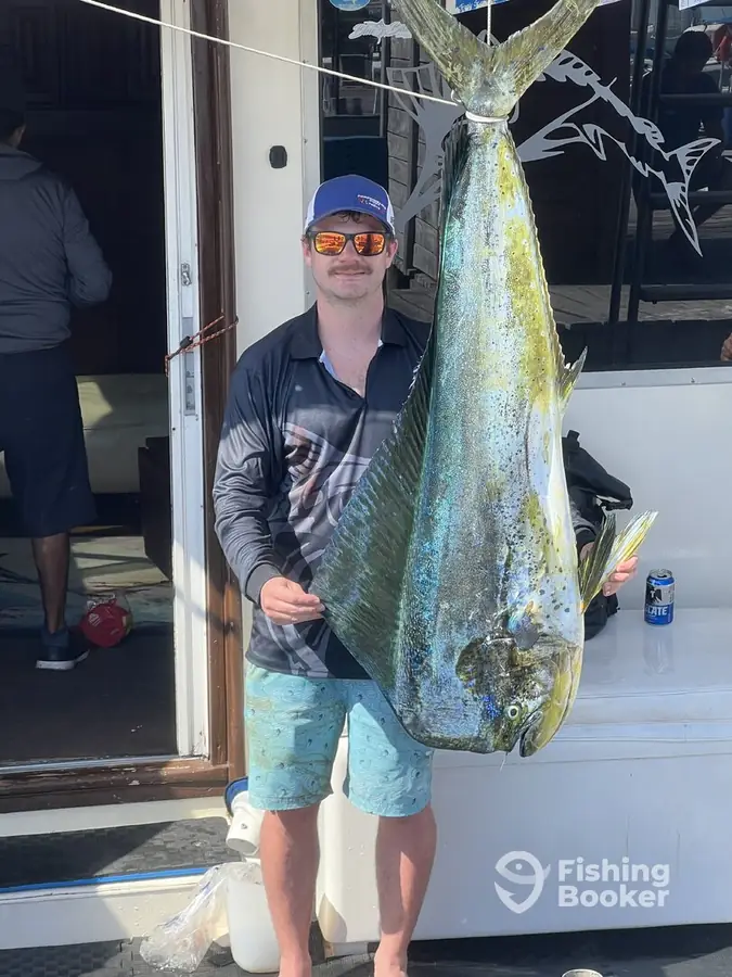 Guest with a 75 lb dorado aboard Cape Escape