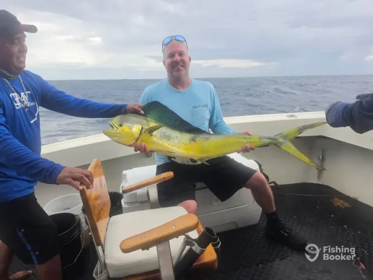 Guests with a big mahi mahi aboard Cape Escape
