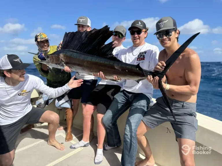 Group of guests with a sailfish aboard Cape Escape