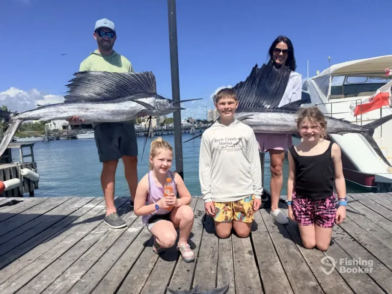 Family of five with a sailfish on the dock