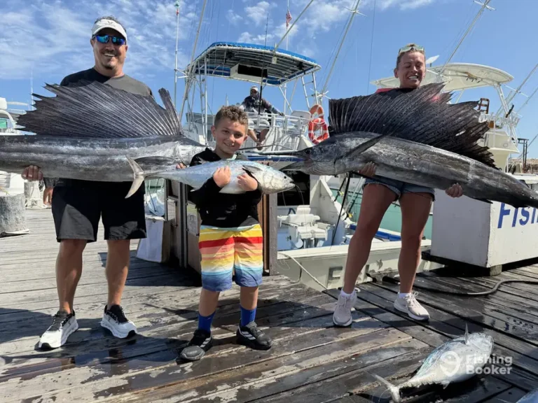 Family with two sailfish on the dock