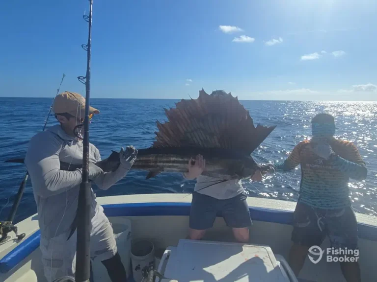 Guests with a sailfish aboard Fish’s