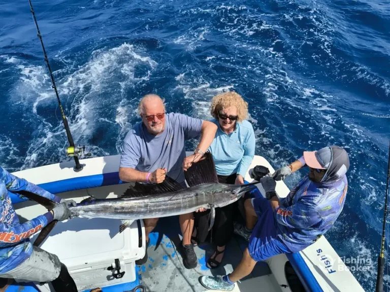 Guests with a sailfish aboard Fish’s
