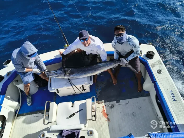 Guest with a sailfish aboard Fish’s