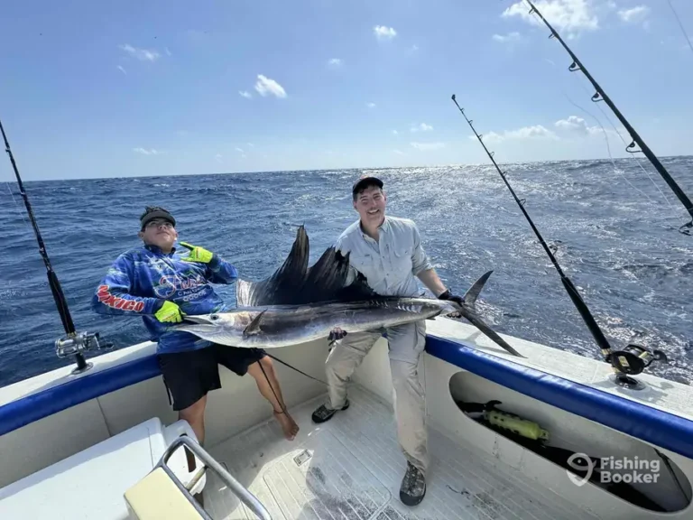 Guest with a sailfish aboard Fish’s