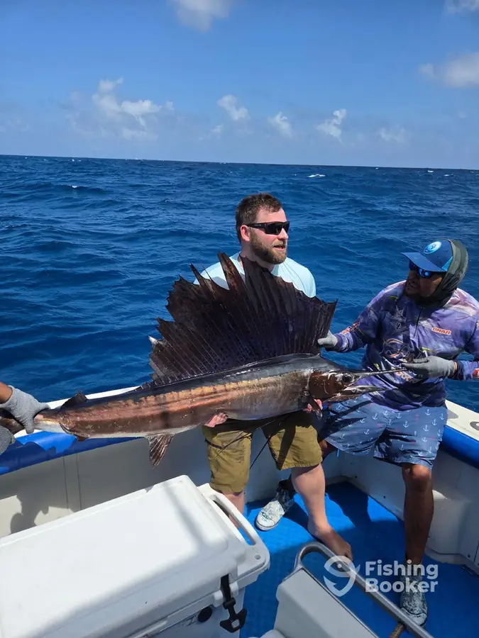 Guest with a sailfish aboard Fish’s