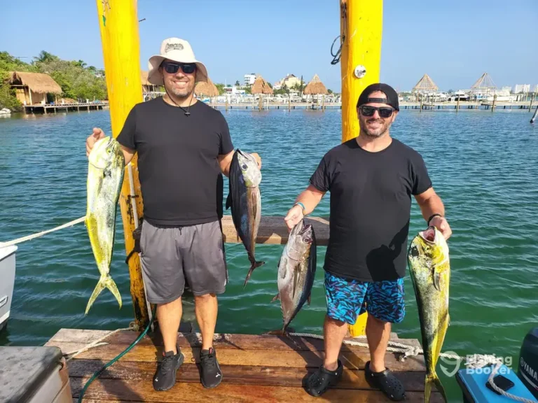 Two anglers with mahi mahi on the dock