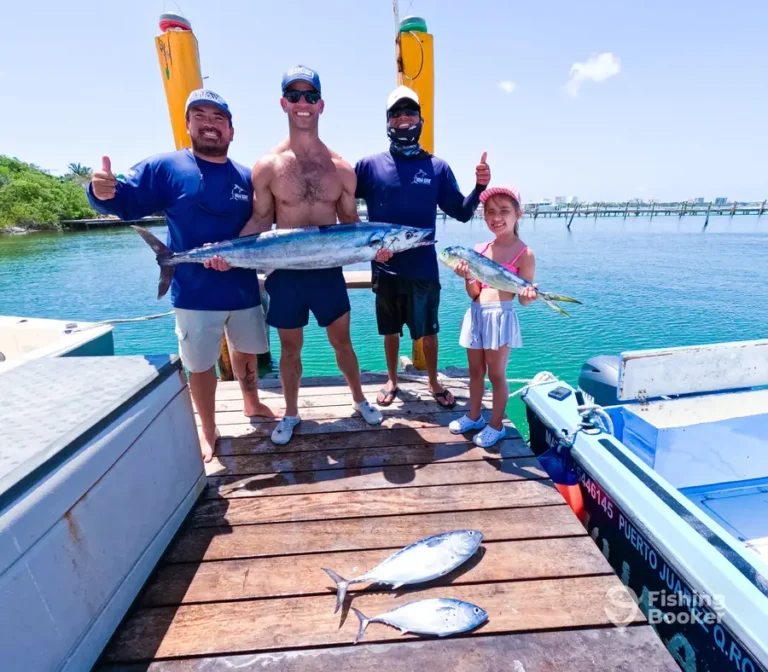 Father and daughter with their catch on the dock