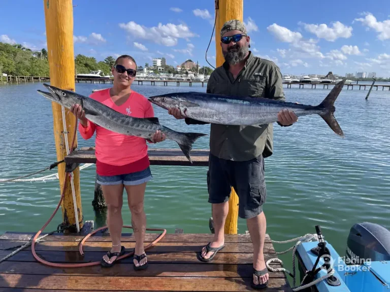 Two guests with wahoo on the dock