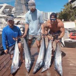 A group of anglers with several fish after a Cancun fishing trip.