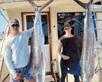 Couple with a marlin and a sailfish on Cape Escape in Cancún