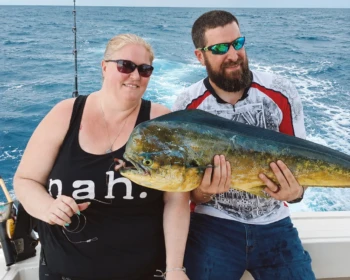 Couple with a mahi-mahi on Cape Escape in Cancún