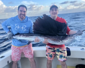 Father and son with a sailfish in Cancún