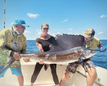 Guests holding a sailfish on Cape Escape in Cancún